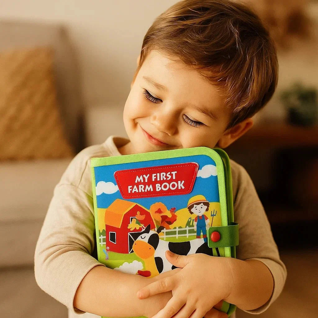 Niño abrazando el libro de fieltro de la granja cerrado